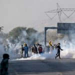 Pakistani police fire tear gas as thousands supporting Imran Khan arrive near capital